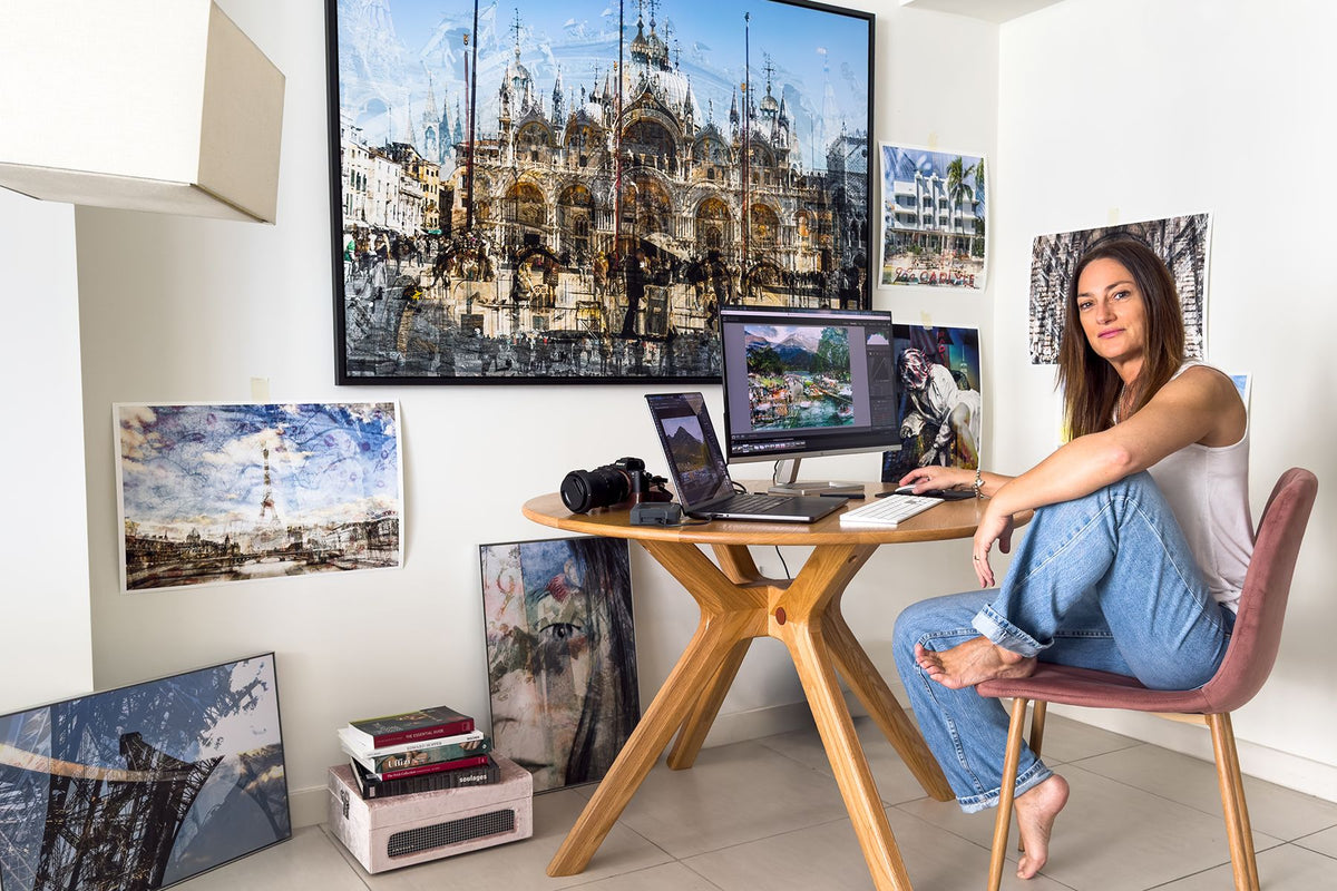 Charlotte Fonne in her studio with her camera, computer and layered photographs, Basilica di San Marco on the wall