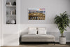 Colosseo layered photography print in a white floater frame, displayed above a daybed in a modern living room