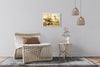 Meknes Medina layered photography print in a white floater frame, on a gray wall beside a woven lounge chair and a rattan side table