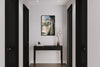 Mirror layered portrait photography print in a black floater frame, displayed above a console table in a modern hallway