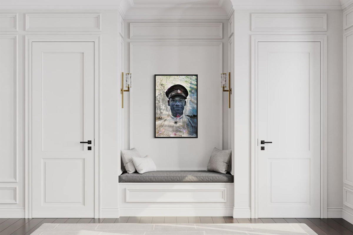 Policeman in Nassau layered portrait photography print in a black floater frame, displayed above a built-in bench in a white paneled hallway